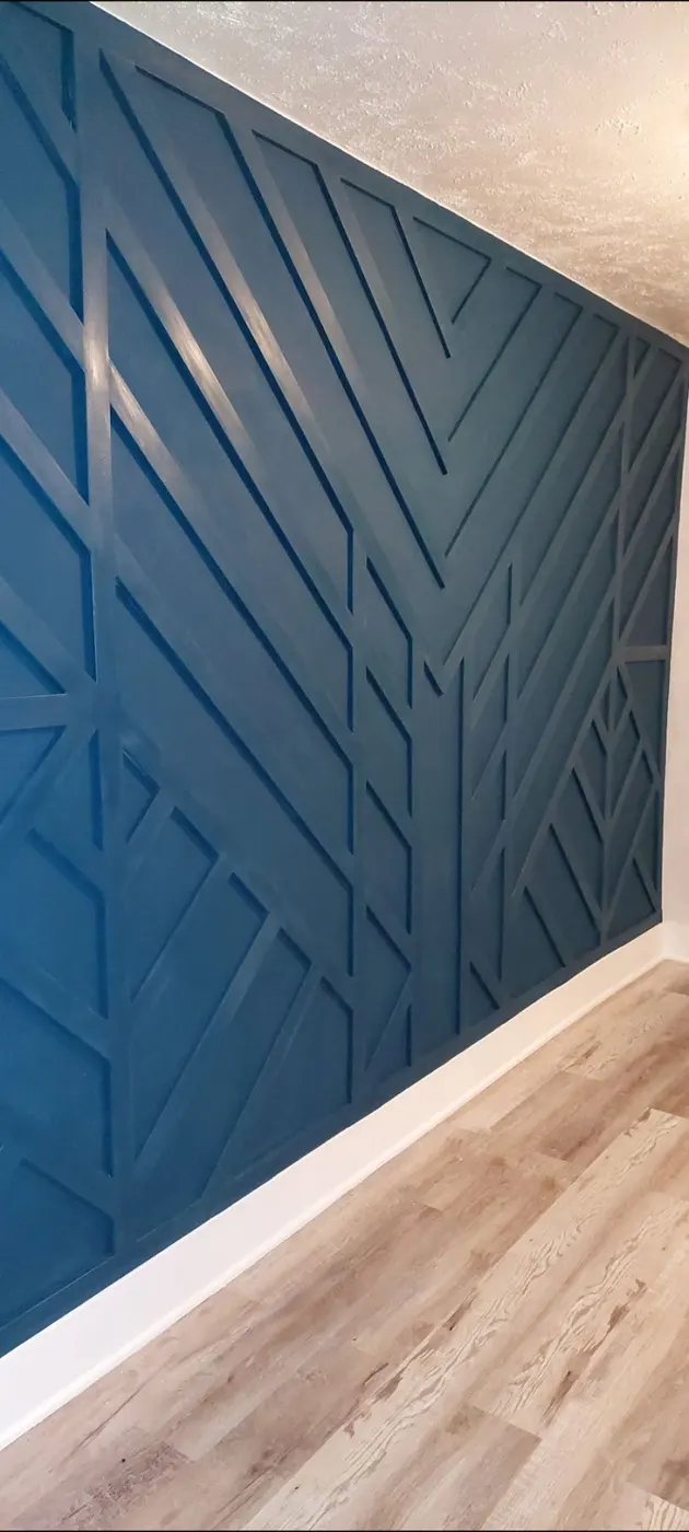 Hallway accent wall with a geometric trim pattern, the wall and the trim both painted navy