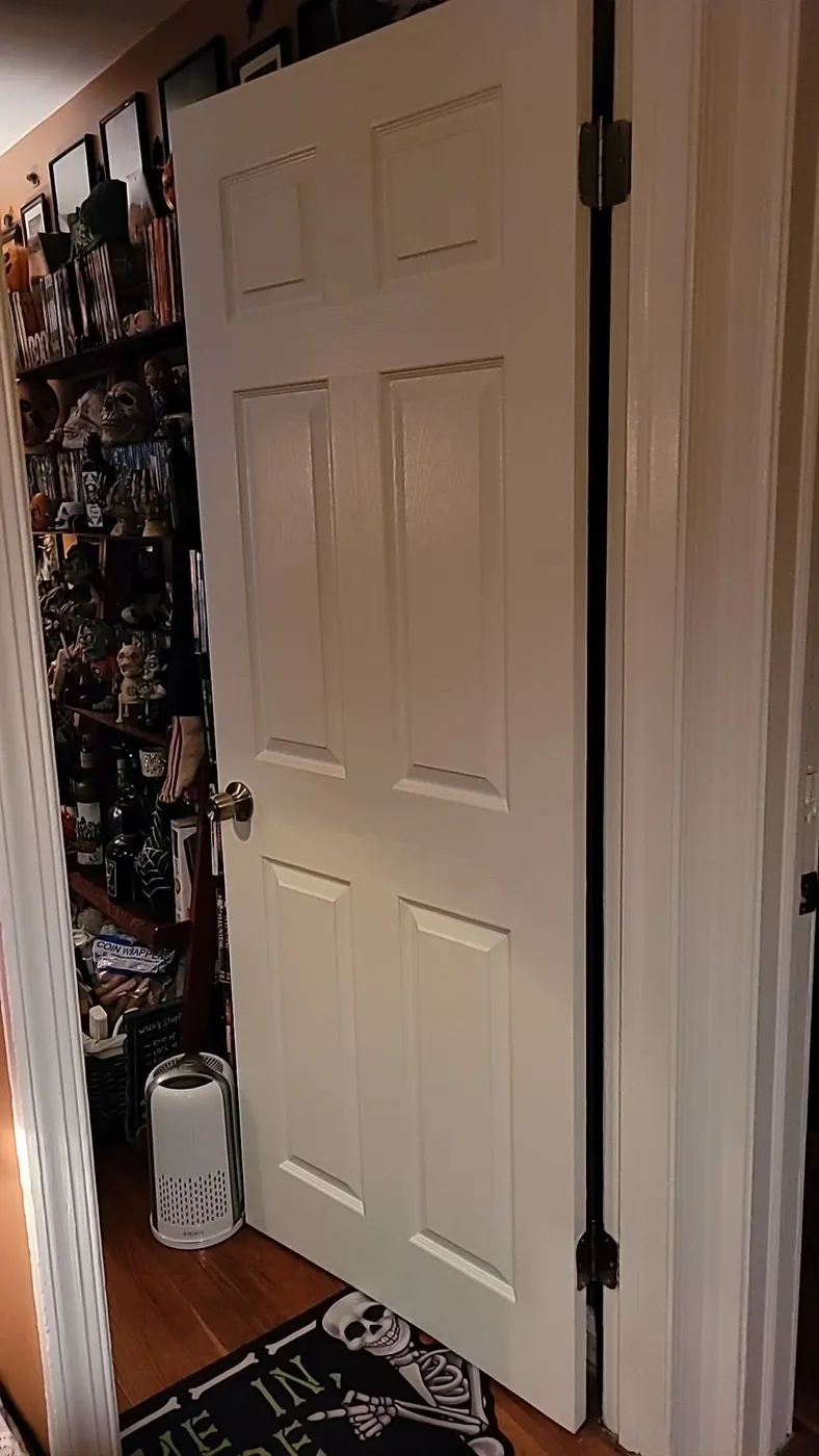 Six-panel interior door and its frame painted white